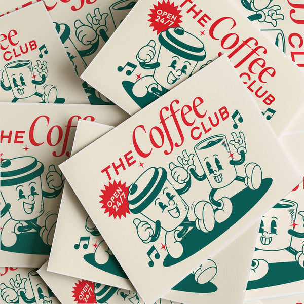 Playful coffee-themed wall print with vintage cartoon mugs, musical notes, and “The Coffee Club” typography. Retro diner kitchen decor.