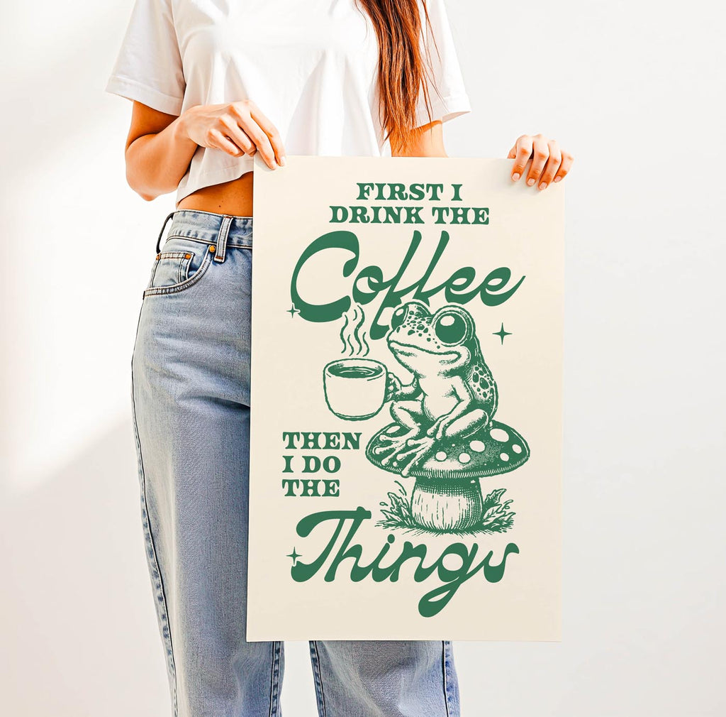 Whimsical “First I Drink the Coffee Then I Do the Things” print featuring a cute frog with a coffee cup sitting on a toadstool—perfect cozy cottagecore wall art for coffee lovers.