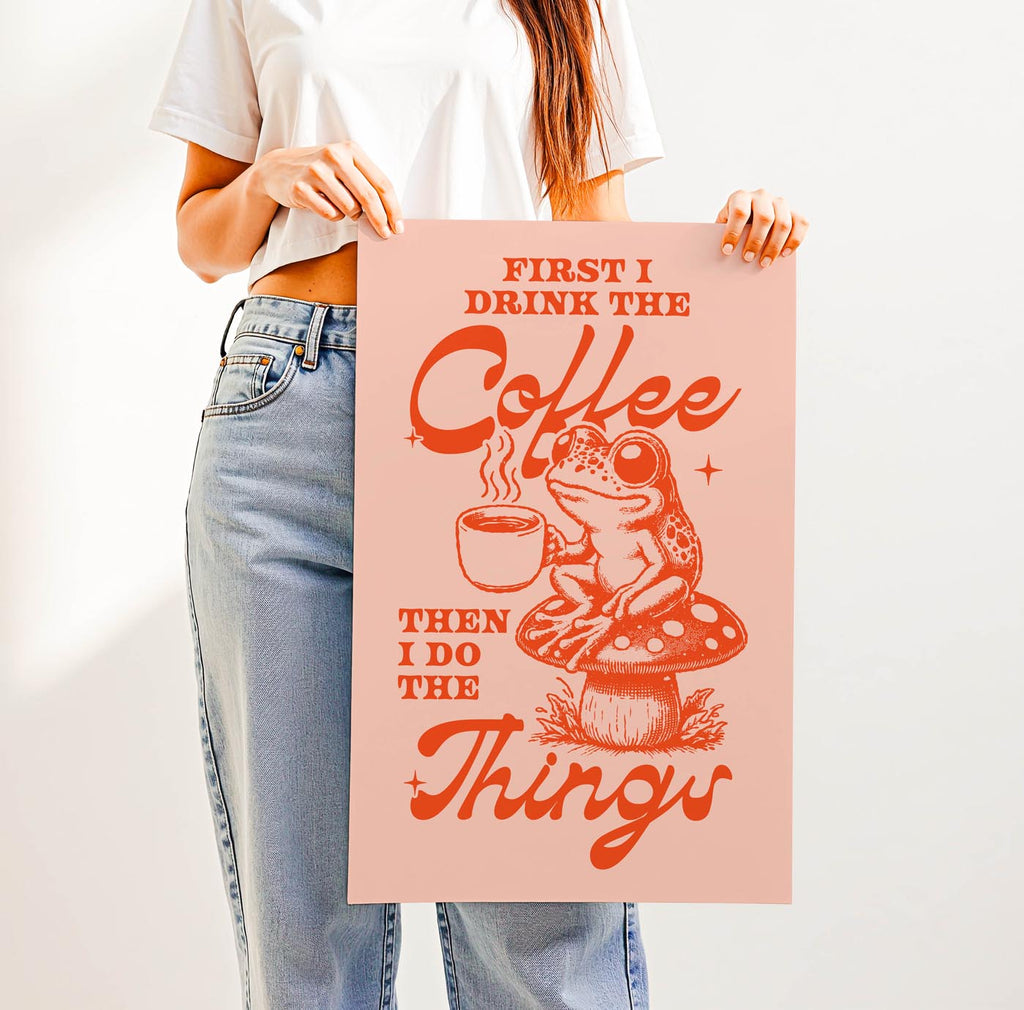 Whimsical “First I Drink the Coffee Then I Do the Things” print featuring a cute frog with a coffee cup sitting on a toadstool—perfect cozy cottagecore wall art for coffee lovers.