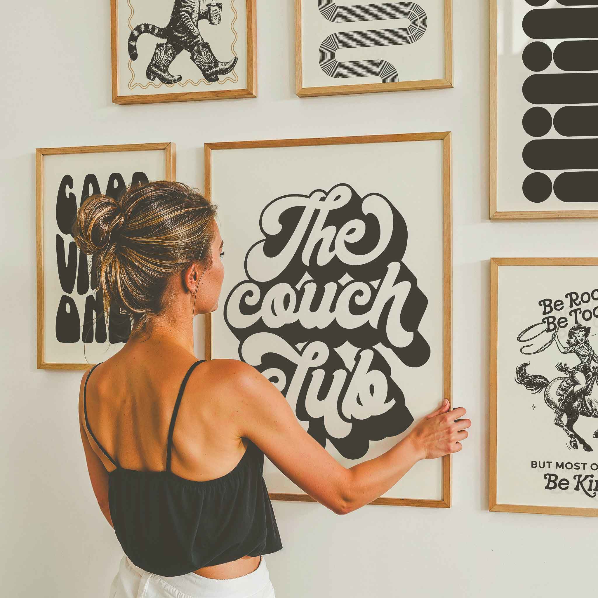 Curated Inprimo gallery wall display featuring “The Couch Club” typography print—cozy, modern wall art arrangement perfect for living rooms and chill spaces.