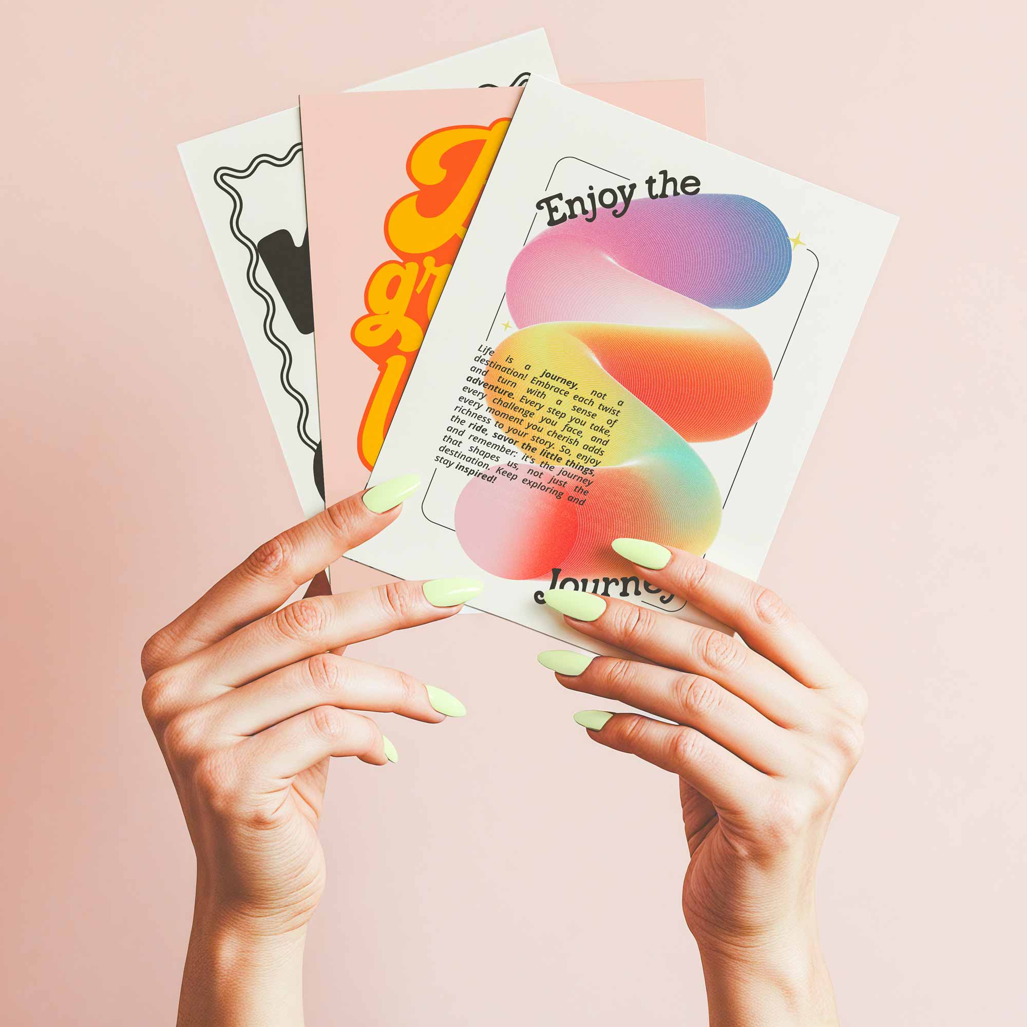 Hand holding colorful retro wall art prints with playful typography and pastel tones, ideal for modern gallery walls.